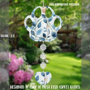 May include: A decorative wind chime featuring a paw print design with blue and white floral patterns, and peach accents. It hangs from a string of crystals and a heart-shaped charm. The text "FREE BACKGROUND INCLUDED" is visible.