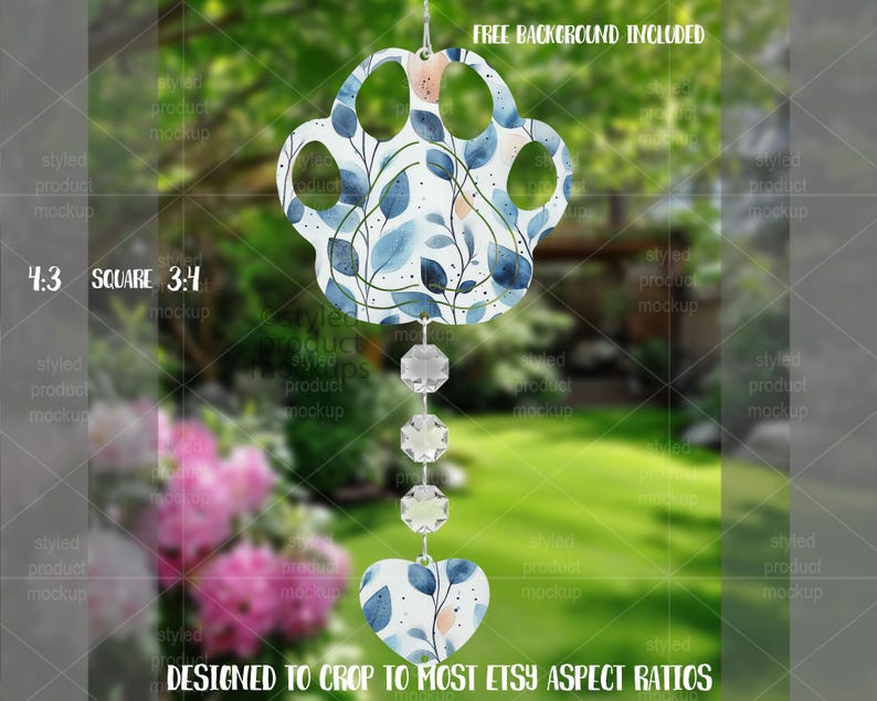 May include: A decorative wind chime featuring a paw print design with blue and white floral patterns, and peach accents. It hangs from a string of crystals and a heart-shaped charm. The text "FREE BACKGROUND INCLUDED" is visible.