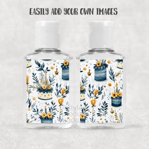 May include: Two clear hand sanitizer bottles with white caps. The labels feature a watercolor floral design with yellow and blue flowers, green leaves, and small gold accents. The text "EASILY ADD YOUR OWN IMAGES" is at the top.