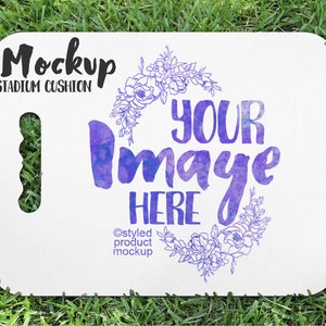 May include: White stadium cushion with a floral design and the text "Your Image Here" in purple watercolor. The text "Mockup Stadium Cushion" is at the top of the cushion.