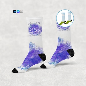 May include: A pair of white crew socks with a purple and blue watercolour design. The socks have black heels and toes. The text "Mockup by SPM" and "YOUR IMAGE HERE" is visible on the socks.