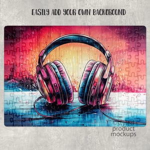 May include: A pair of pink and black headphones with a colorful abstract background. The background features a jigsaw puzzle pattern with red, blue, and yellow colors.