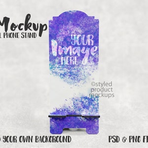 May include: A purple and blue watercolor cell phone stand mockup with the text "YOUR IMAGE HERE" and the copyright information "@styled product mockups".