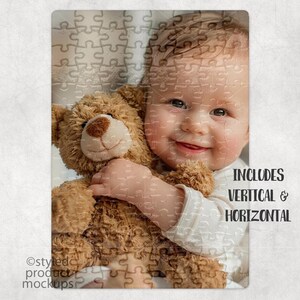 May include: A baby holding a brown teddy bear. The baby is wearing a white shirt and has a happy expression. The image includes the text "INCLUDES VERTICAL & HORIZONTAL".