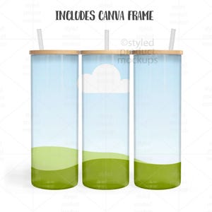 May include: Three tall, cylindrical tumblers with bamboo lids and straws. The tumblers feature a sky-blue background with a green landscape design. One tumbler has a white cloud graphic. The text "INCLUDES CANVA FRAME" is at the top.