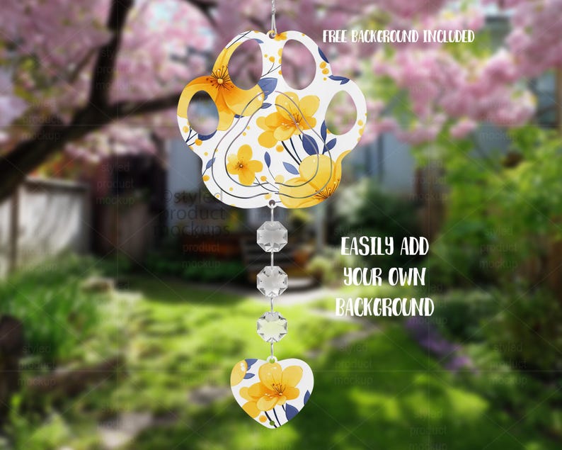 May include: A paw-shaped ornament with yellow floral designs and blue accents, suspended by a string of clear crystals. A heart-shaped charm with matching floral patterns hangs below. The text "FREE BACKGROUND INCLUDED" and "EASILY ADD YOUR OWN BACKGROUND" are visible.