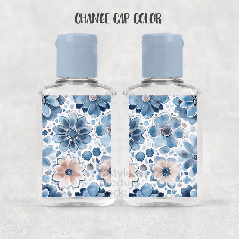 May include: Two clear, rectangular bottles with light blue caps. The bottles feature a floral design with blue and peach flowers on a white background. The text "CHANGE CAP COLOR" is above the bottles.