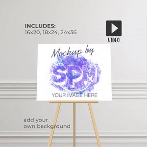 May include: A white rectangular sign on a wooden easel featuring the text Mockup by SPM and YOUR IMAGE HERE with a purple watercolor circle graphic. The sign includes dimensions 16x20, 18x24, 24x36 and a video icon in the upper right corner.