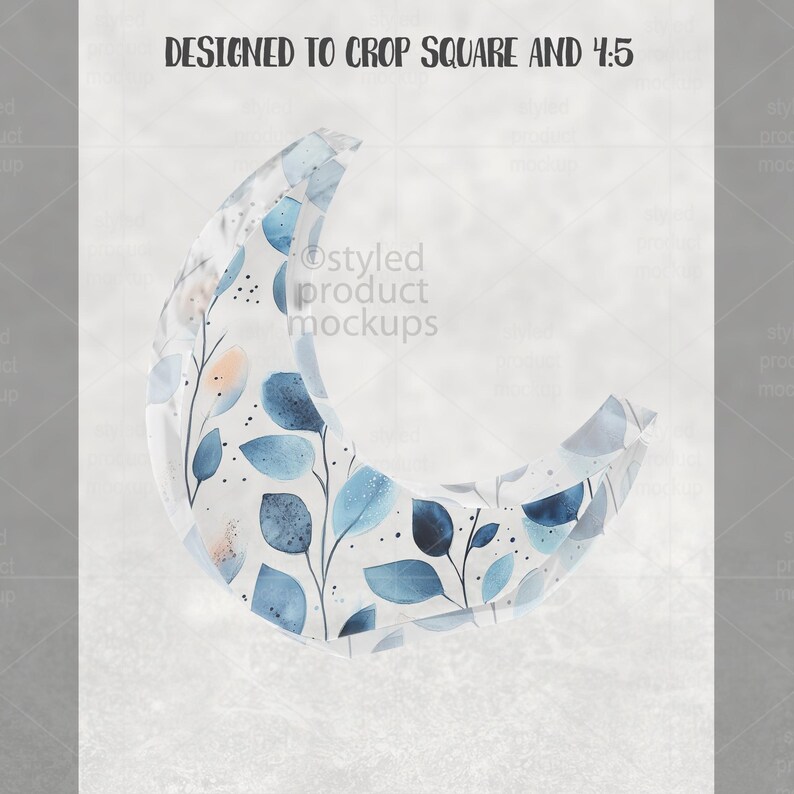 May include: A crescent-shaped design with a watercolor pattern of blue leaves and branches. The design is set against a light gray background. Text at the top reads "DESIGNED TO CROP SQUARE AND 4:5". The words "Styled product mockups" are also visible.