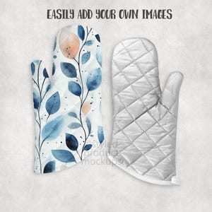May include: Two oven mitts. One features a watercolor design of blue leaves and peach-colored accents on a white background. The other is a quilted, solid white oven mitt. The text "EASILY ADD YOUR OWN IMAGES" is at the top.