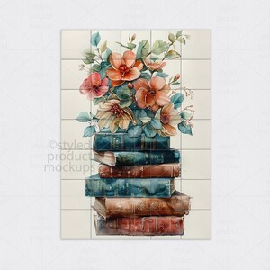 Op de afbeelding: Een aquarel afbeelding van een stapel boeken met een bloemstuk. De boeken hebben blauwe, bruine en rode covers. De bloemen zijn perzik en roze met groene bladeren, tegen een witte tegel achtergrond.