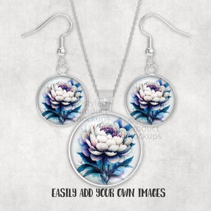 May include: A jewellery set with a floral design. The set includes a necklace pendant and a pair of earrings. Each piece has a round, silver-toned frame with a watercolour-style image of a white and purple peony flower with blue leaves.