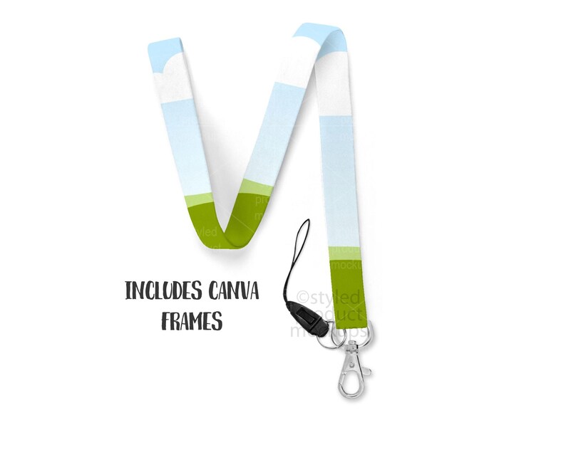 May include: A lanyard with a landscape design featuring blue sky, green fields, and white clouds. The lanyard has a black cord, a silver-colored metal clasp, and the text "INCLUDES CANVA FRAMES".