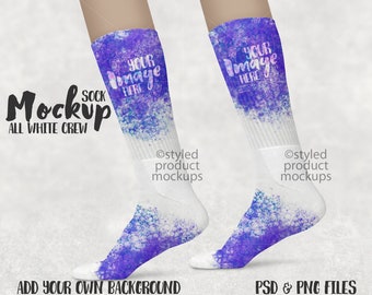 May include: A pair of white crew socks with a purple and blue watercolor design. The socks have the text "YOUR IMAGE HERE" on the upper part. The words "Sock Mockup ALL WHITE CREW" are also visible. The image also includes the text "ADD YOUR OWN BACKGROUND" and "PSD & PNG FILES".