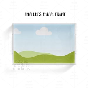 May include: A rectangular clear acrylic frame with a landscape scene inside. The scene features a blue sky with two white clouds and green rolling hills. The text "INCLUDES CANVA FRAME" is printed at the top.