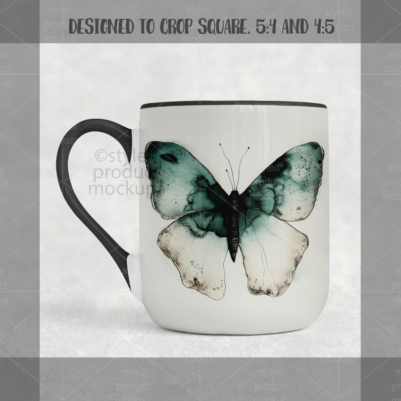 May include: White ceramic mug with a black handle and rim. The mug features a watercolor-style butterfly design in shades of teal, green, and white. The mug is designed to crop square, 5:4 and 4:5.