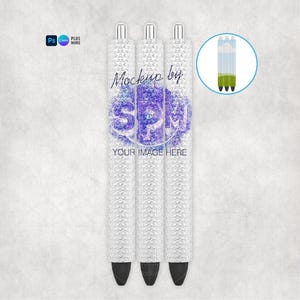 May include: Three white pens with silver detailing and black tips. The pens feature a textured pattern and a purple and blue floral design with the text "Mockup by SPM" and "YOUR IMAGE HERE". A circular graphic shows the pen's ink.