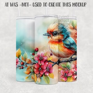 May include: A set of three stainless steel tumblers with lids and straws. The tumblers feature a watercolor design of a colorful bird perched on a branch with pink flowers and berries. The background is a soft blend of colors.