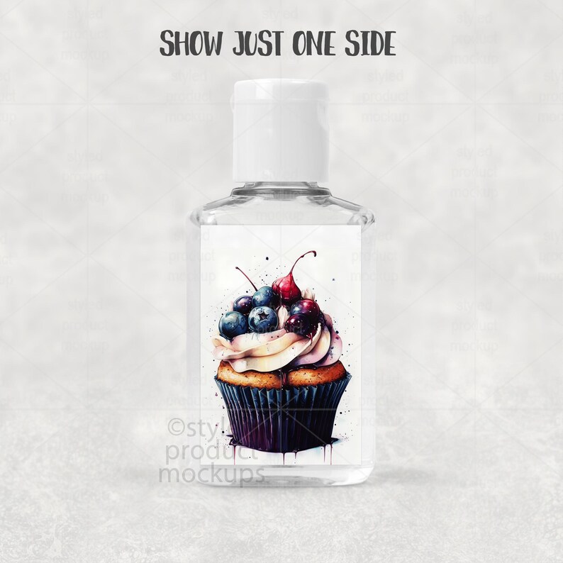 May include: Clear hand sanitizer bottle with a white cap. The label features a watercolor cupcake design topped with blueberries and cherries. Text on the top reads "SHOW JUST ONE SIDE". The bottom of the label has the text "Osty! product mockups".