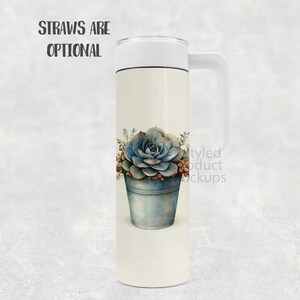 May include: A white travel mug with a handle and a white lid. The mug features a watercolour illustration of a blue succulent in a metal bucket. The text "STRAWS ARE OPTIONAL" is at the top. The mug is designed for hot or cold beverages.