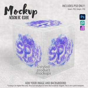 May include: A clear acrylic cube mockup with a purple and blue watercolor design on each side. The design features the letters "SPM" in a stylized font. The text "Mockup Acrylic Cube" is at the top of the image. The text "Ostyled product mockups" is at the bottom of the image.