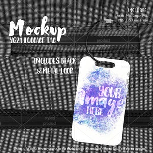 May include: A white luggage tag mockup with a watercolor background. The tag has a black metal loop and the text "YOUR IMAGE HERE" is printed on it. The tag is hanging from a black zippered bag.