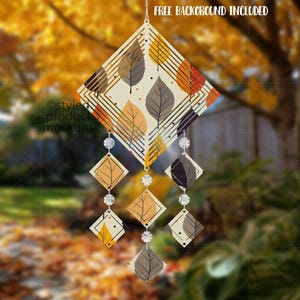 May include: A decorative wind chime with a diamond-shaped top featuring leaf patterns in orange, yellow, and grey. The chime has dangling diamond-shaped accents and clear crystal beads. The text "FREE BACKGROUND INCLUDED" is at the top.