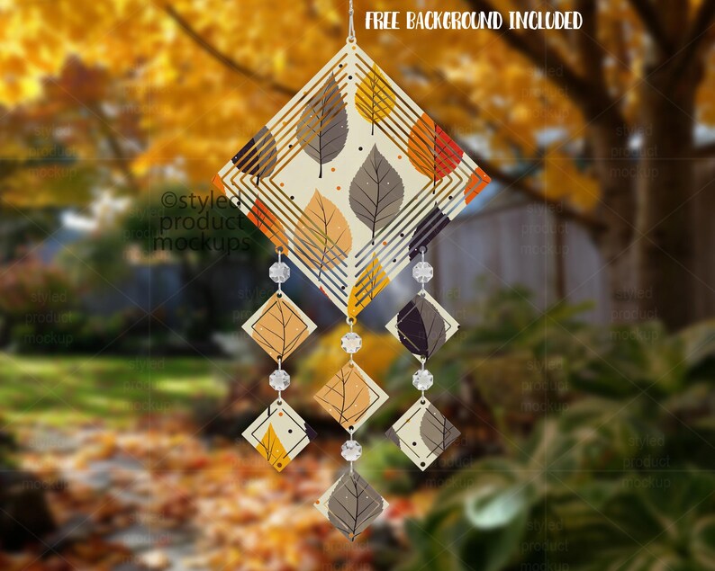 May include: A decorative wind chime with a diamond-shaped top featuring leaf patterns in orange, yellow, and grey. The chime has dangling diamond-shaped accents and clear crystal beads. The text "FREE BACKGROUND INCLUDED" is at the top.