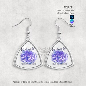 May include: A pair of silver-toned earrings with a triangular design. Each earring features a white background with a purple and blue graphic and the text "SPM" and "YOUR IMAGE HERE". The earrings are displayed on a light gray textured surface.