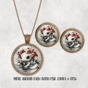 Może przedstawiać: Zestaw naszyjnika z wisiorkiem i pasujących kolczyk&oacute;w. Wisiorek i kolczyki przedstawiają akwarelową ilustrację aksolotla w koronie z kwiat&oacute;w. Aksolotl jest biały z czarnymi oczami i czerwoną koroną z kwiat&oacute;w. Biżuteria ma ramkę w kolorze brązu.