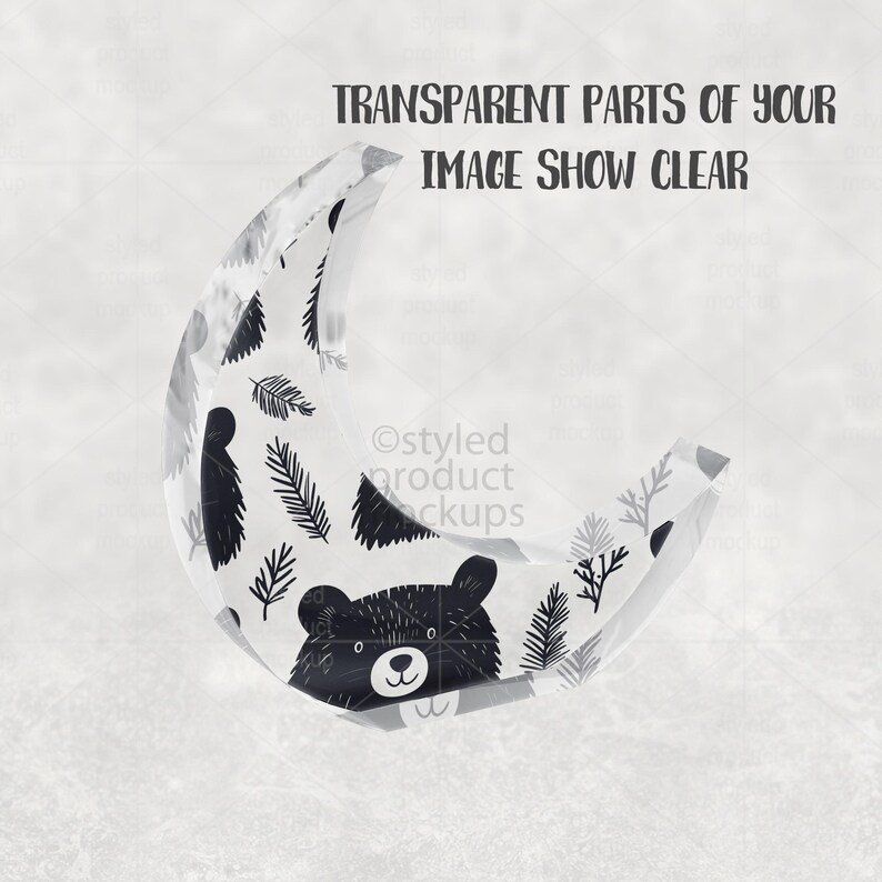 May include: A clear, crescent-shaped decorative item with a black and white bear face and leaf pattern. The text "TRANSPARENT PARTS OF YOUR IMAGE SHOW CLEAR" is printed at the top.