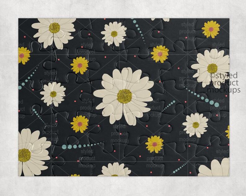 May include: A black jigsaw puzzle with a white daisy pattern. The puzzle pieces are arranged in a grid pattern and have a textured surface. The text "Styled Product Mockups" is printed in white on the puzzle.