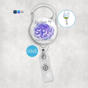 May include: A white retractable badge holder with a silver carabiner clip. The holder features the text "Mockup by SPM" and "Your Image Here" over a purple watercolour design. A smaller circular image shows a badge holder with a green and blue design. The words "Color Change" are in a blue circle.