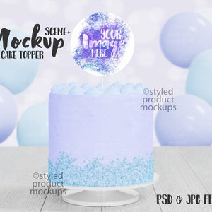 May include: A purple and blue frosted cake with blue sprinkles on top. A round cake topper with a watercolor design says "Your Image Here". The cake is on a white cake stand and surrounded by blue balloons.