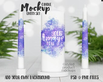 Puede incluir: Una maqueta de un juego de velas de unidad con dos velas más pequeñas y una vela más grande en el centro. Las velas son blancas con un diseño de acuarela azul y morado. El texto "YOUR IMAGE HERE" está en la vela más grande. Las velas están sobre una superficie de madera con una planta verde en el fondo.