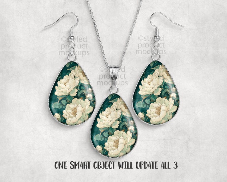 May include: A jewelry set featuring a pendant necklace and matching earrings. The teardrop-shaped pieces have a dark teal background with a floral pattern in cream and green. The text "ONE SMART OBJECT WILL UPDATE ALL 3" is at the bottom.