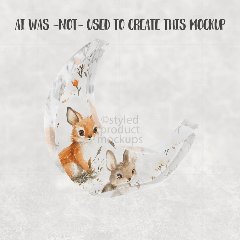 May include: A clear, crescent-shaped decorative item featuring a watercolor illustration of a fox and a rabbit. The artwork includes floral elements in orange and brown tones. The text "AI WAS -NOT- USED TO CREATE THIS MOCKUP" is visible at the top.