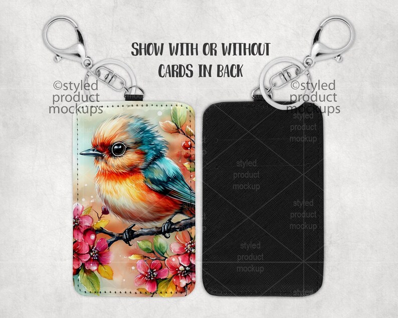 May include: A keychain with a black leatherette card holder featuring a colorful bird illustration with pink flowers. The text "SHOW WITH OR WITHOUT CARDS IN BACK" is printed on the image.
