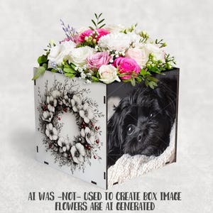 May include: A square white box with a floral wreath design and a black and white image of a dog. The box is filled with a bouquet of pink, white, and green flowers. The text at the bottom reads "AI WAS -NOT- USED TO CREATE BOX IMAGE FLOWERS ARE AI GENERATED."