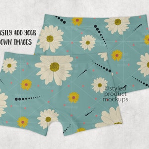 May include: Two pairs of blue boxer shorts with a white daisy and yellow flower pattern. The shorts have a black dotted line pattern. The text "EASILY ADD YOUR OWN IMAGES" is visible at the top of the image.