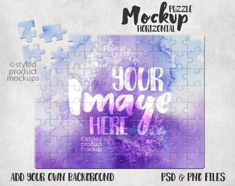 May include: A purple and blue watercolor jigsaw puzzle mockup with the text "YOUR IMAGE HERE" in white. The puzzle is missing a few pieces. The text "PUZZLE MOCKUP HORIZONTAL" is at the top of the image. The text "ADD YOUR OWN BACKGROUND" is at the bottom of the image. The text "PSD & PNG FILES" is at the bottom right of the image.