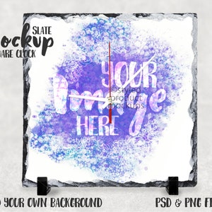 Könnte beinhalten: Ein quadratischer Schieferuhren-Mockup mit einem lila und blauen Aquarellhintergrund. Das Zifferblatt der Uhr ist weiß mit schwarzen Zeigern und dem Text "YOUR IMAGE HERE" in weißen Buchstaben.