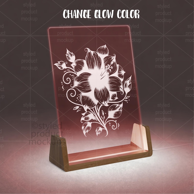 K&ouml;nnte beinhalten: Ein leuchtendes, rechteckiges Acrylschild mit floralem Design, das in einem Holzsockel steht. Das Schild zeigt eine wei&szlig;e Blumenillustration auf rotem Hintergrund. Der Text "CHANGE GLOW COLOR" steht oben.