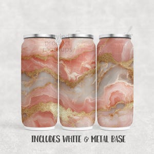 May include: Three tall, insulated tumblers with a marble-like design in shades of pink, white, and gold. Each tumbler has a silver lid, and one includes a straw. The text "INCLUDES WHITE & METAL BASE" is at the bottom.