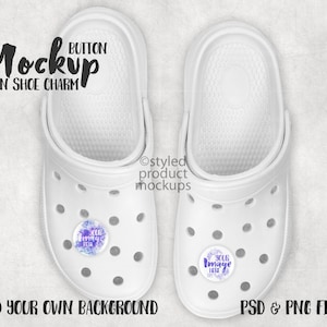 May include: A mockup of a white garden shoe charm with a round button. The button has a white background with a purple floral design and the text "Your Image Here". The text "BUTTON MOCKUP GARDEN SHOE CHARM" is at the top of the image. The text "ADD YOUR OWN BACKGROUND" is at the bottom left of the image. The text "PSD & PNG FILES" is at the bottom right of the image.