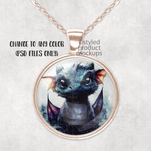 May include: A necklace with a round glass pendant featuring a blue and purple dragon illustration. The pendant is attached to a rose gold chain.
