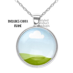 May include: Silver necklace with a round glass pendant featuring a blue sky with a white cloud and a green grassy hill.