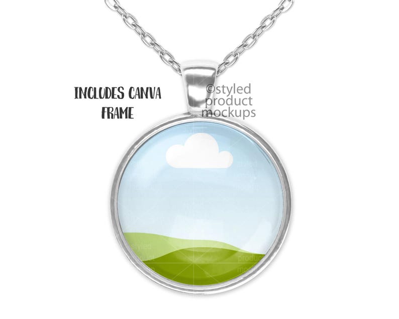 May include: Silver necklace with a round glass pendant featuring a blue sky with a white cloud and a green grassy hill.