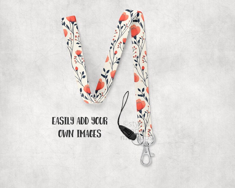 May include: A floral lanyard with a cream background, featuring red flowers and navy leaves. The lanyard has a black clasp and a silver metal clip. The text "EASILY ADD YOUR OWN IMAGES" is printed in black.