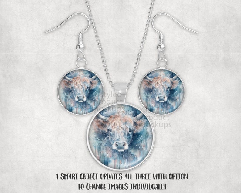 May include: A silver necklace and earring set. Each piece has a circular pendant with a watercolour image of a Highland cow. The cow has brown fur and blue accents. The text at the bottom reads "1 SMART OBJECT UPDATES ALL THREE WITH OPTION TO CHANGE IMAGES INDIVIDUALLY."